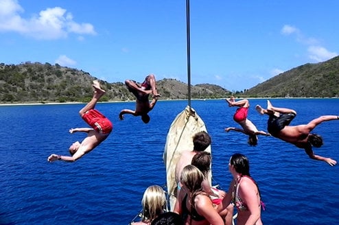 people jumping off boats