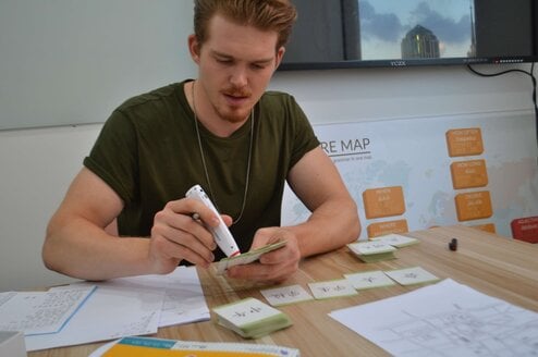 Person gluing flashcards