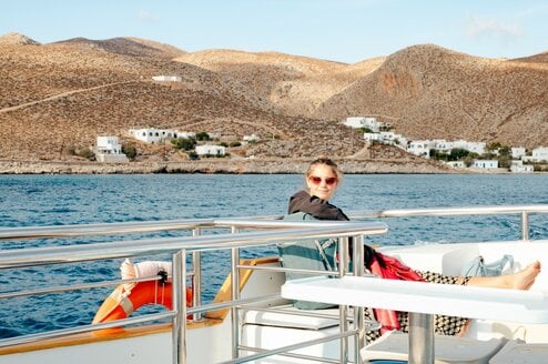 A person relaxing on a boat near the shoreline